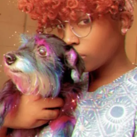 Erika, holding a dog with colorful hair